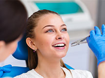 Girl getting a tooth removed at dental office
